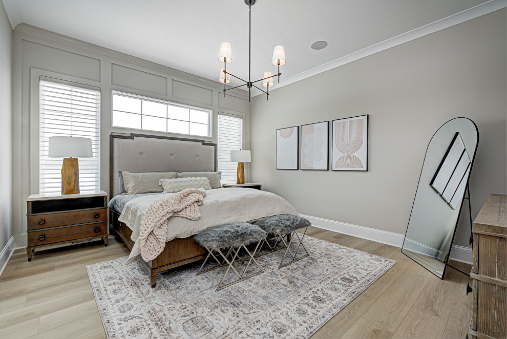 This is an example of a medium sized rural master bedroom in Indianapolis with beige walls, medium hardwood flooring and brown floors.