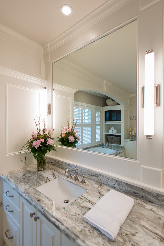 Large transitional bathroom in Houston with raised-panel cabinets, white cabinets, a drop-in tub, a one-piece toilet, beige tile, porcelain tile, white walls, limestone floors, an undermount sink, engineered quartz benchtops and with a sauna.