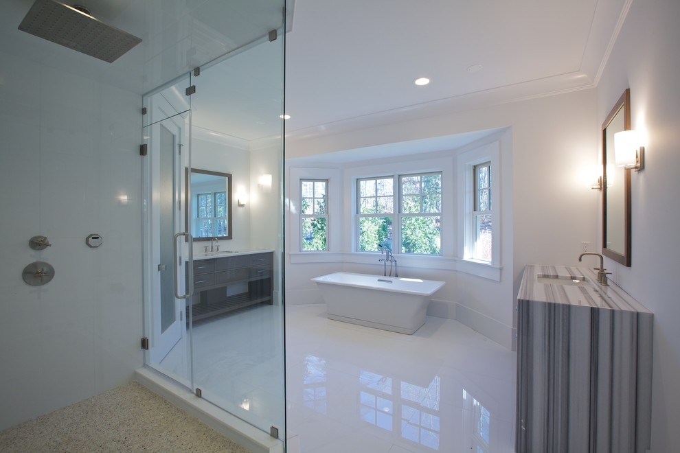 Example of a large transitional master white tile and glass tile porcelain tile freestanding bathtub design with furniture-like cabinets, dark wood cabinets, a two-piece toilet, white walls, an undermount sink and quartzite countertops