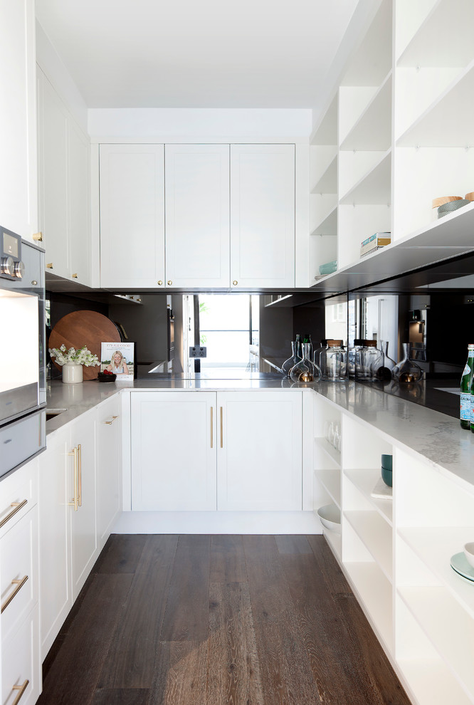 This is an example of a large transitional galley kitchen in Melbourne with a single-bowl sink, shaker cabinets, yellow cabinets, quartz benchtops, yellow splashback, stone slab splashback, stainless steel appliances, medium hardwood floors and with island.