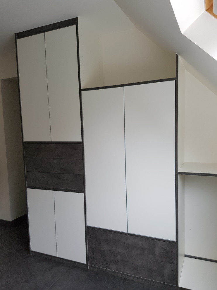 This is an example of a large contemporary gender-neutral walk-in wardrobe in Angers with beaded inset cabinets, white cabinets and dark hardwood floors.