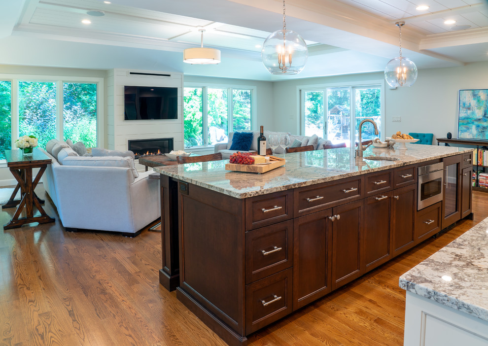 Inspiration for a kitchen remodel in Boston with white cabinets, mosaic tile backsplash, stainless steel appliances and an island