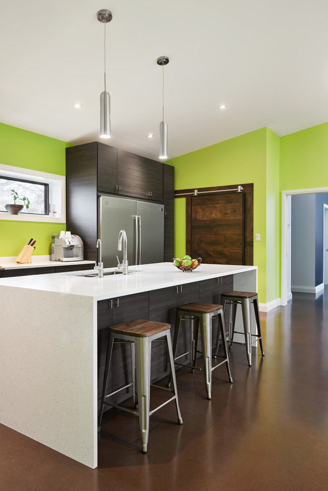 Mid-sized contemporary single-wall open plan kitchen in Toronto with an undermount sink, flat-panel cabinets, dark wood cabinets, quartz benchtops, green splashback, stainless steel appliances, concrete floors and with island.
