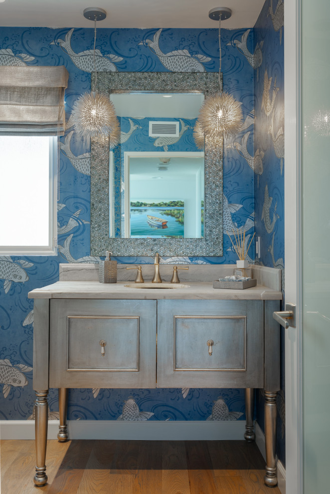 Inspiration for a medium sized coastal cloakroom in Los Angeles with beaded cabinets, grey cabinets, medium hardwood flooring, a submerged sink, quartz worktops, multi-coloured worktops, a freestanding vanity unit and wallpapered walls.
