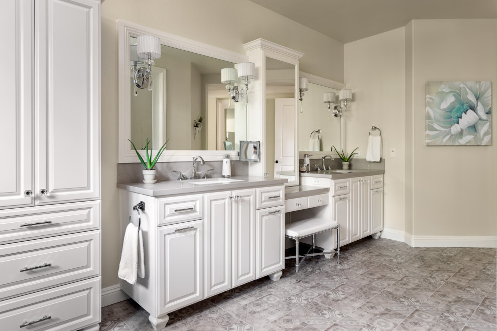 This is an example of a large traditional master bathroom in San Diego with raised-panel cabinets, white cabinets, a double shower, a two-piece toilet, multi-coloured tile, ceramic tile, beige walls, mosaic tile floors, an undermount sink, engineered quartz benchtops, multi-coloured floor, a hinged shower door and beige benchtops.