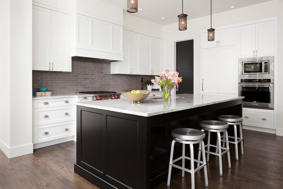 Inspiration for an expansive transitional galley open plan kitchen in Calgary with an undermount sink, shaker cabinets, white cabinets, quartzite benchtops, grey splashback, subway tile splashback, stainless steel appliances, dark hardwood floors and with island.