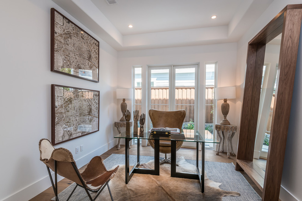 Inspiration for a transitional freestanding desk medium tone wood floor and beige floor study room remodel in Los Angeles with white walls