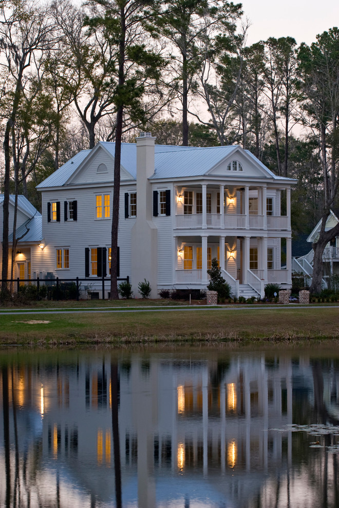This is an example of a traditional two-storey white exterior in Charleston with a gable roof.