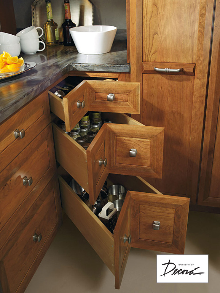 Example of a small l-shaped eat-in kitchen design with medium tone wood cabinets, stainless steel appliances, a peninsula and gray countertops