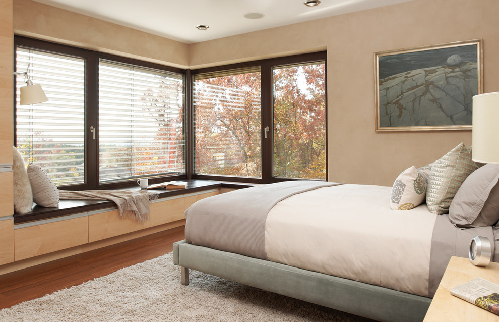 Contemporary bedroom in Minneapolis with beige walls and dark hardwood floors.