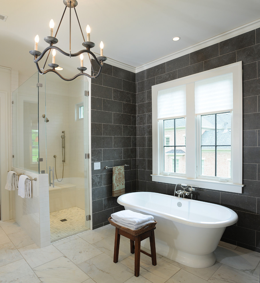 This is an example of a traditional bathroom in Nashville with a freestanding tub, a corner shower and black tile.