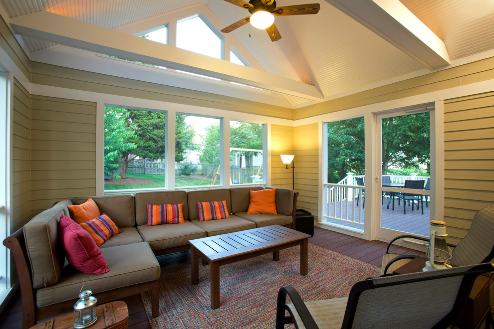 This is an example of a traditional sunroom in DC Metro with dark hardwood floors and a standard ceiling.