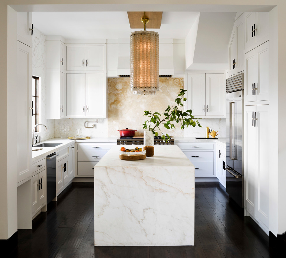This is an example of a transitional kitchen in Chicago with recessed-panel cabinets, white cabinets, marble benchtops, yellow splashback, stone slab splashback and with island.