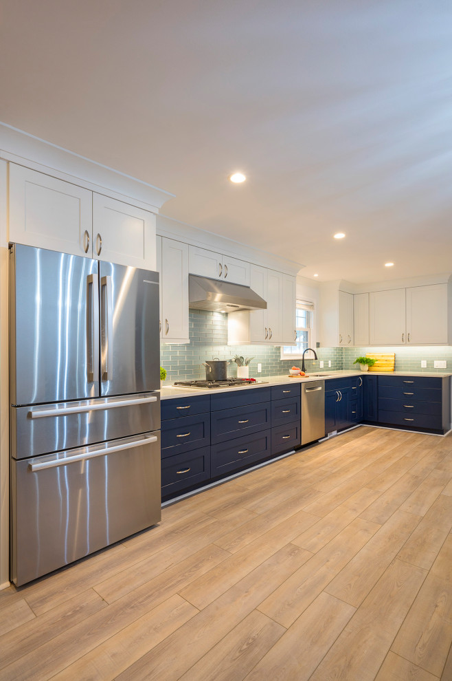 Inspiration for a large transitional u-shaped vinyl floor and beige floor enclosed kitchen remodel in Charleston with an undermount sink, recessed-panel cabinets, blue cabinets, quartz countertops, blue backsplash, glass tile backsplash, stainless steel appliances, no island and white countertops