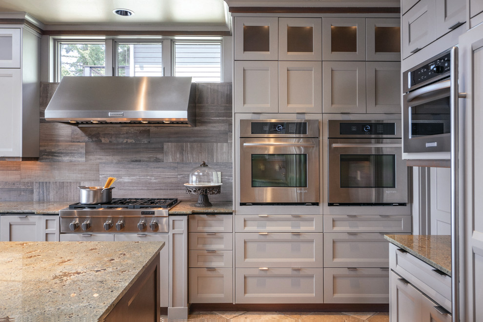 Large transitional kitchen in Seattle with recessed-panel cabinets, grey cabinets, granite benchtops, stainless steel appliances and with island.