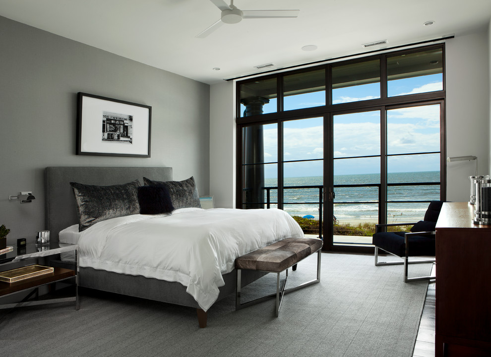 This is an example of a contemporary master bedroom in Charleston with grey walls.