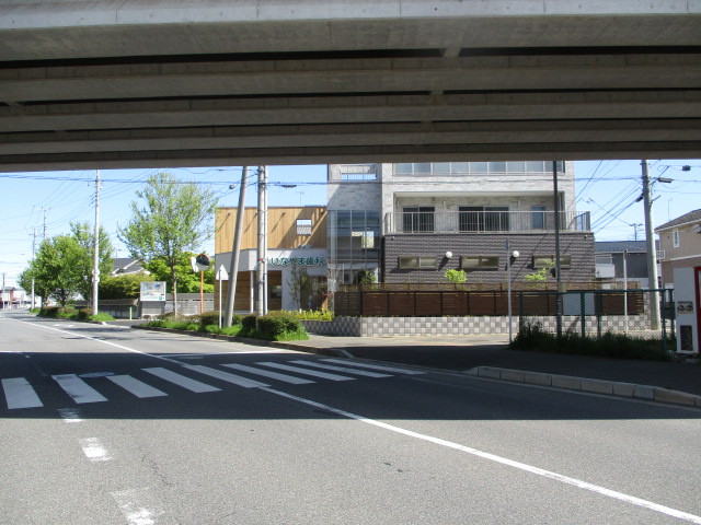 道路南側から高速鉄道の高架の下から建物を見る