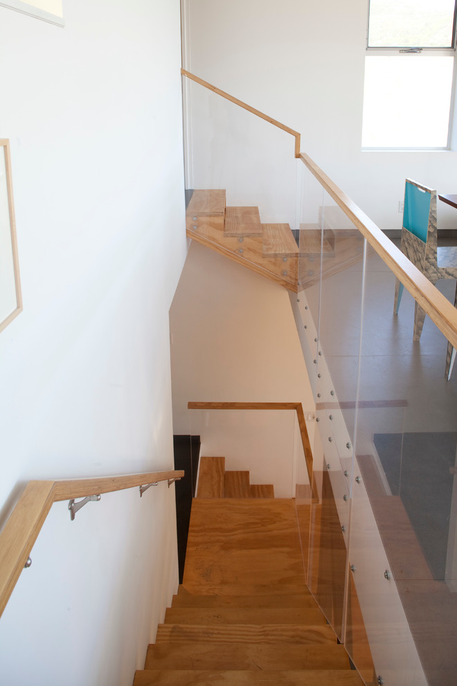 Mid-sized midcentury wood straight staircase in Los Angeles with wood risers.