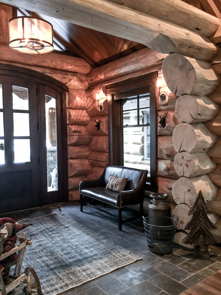 Mid-sized mountain style front door photo in Calgary with a dark wood front door