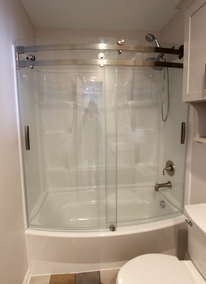 This is an example of a mid-sized bathroom in Cleveland with flat-panel cabinets and white cabinets.