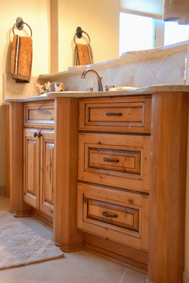 Large mountain style master travertine floor and beige floor bathroom photo with raised-panel cabinets, light wood cabinets, beige walls, an undermount sink and quartz countertops