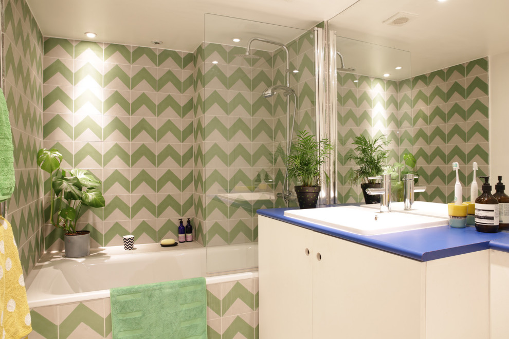 Источник вдохновения для домашнего уюта: ванная комната в стиле фьюжн с плоскими фасадами, белыми фасадами, ванной в нише, душем над ванной, зеленой плиткой, накладной раковиной, синей столешницей, тумбой под одну раковину и встроенной тумбой