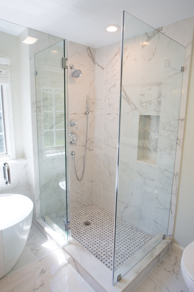 This is an example of a mid-sized transitional master bathroom in DC Metro with an undermount sink, recessed-panel cabinets, medium wood cabinets, engineered quartz benchtops, a freestanding tub, a corner shower, white tile, ceramic tile, beige walls and ceramic floors.