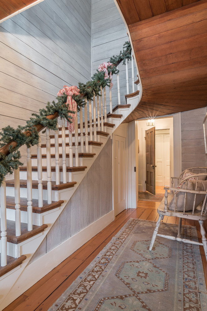 Inspiration for a mid-sized rustic wooden curved staircase remodel with wooden risers