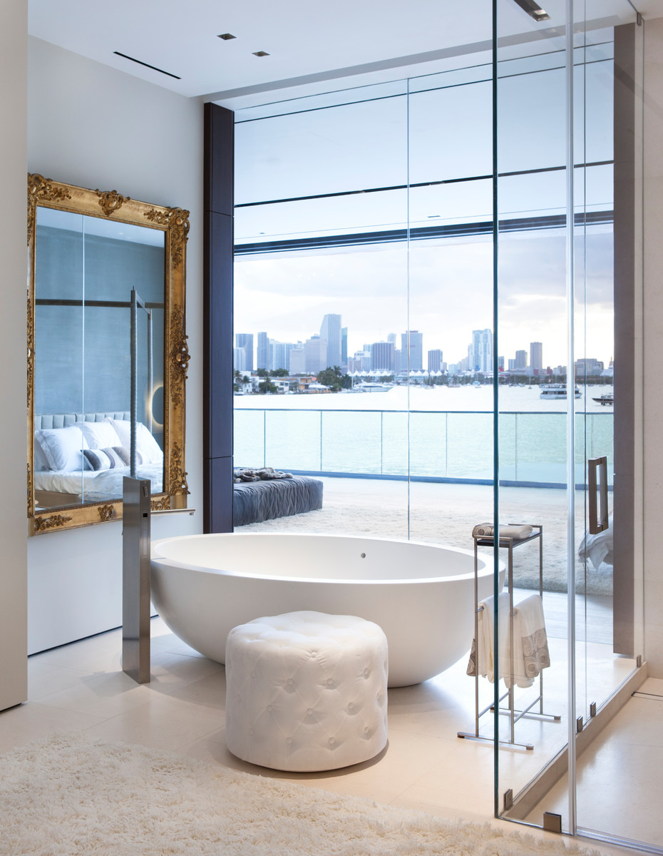 Inspiration for a contemporary bathroom in Miami with a freestanding tub and white floor.