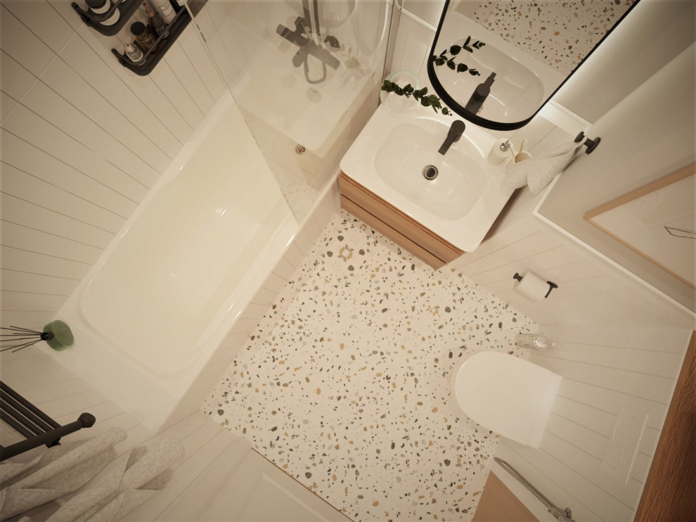 На фото: маленькая главная ванная комната в белых тонах с отделкой деревом в скандинавском стиле с бежевыми фасадами, инсталляцией, белой плиткой, полом из керамогранита, тумбой под одну раковину и подвесной тумбой для на участке и в саду