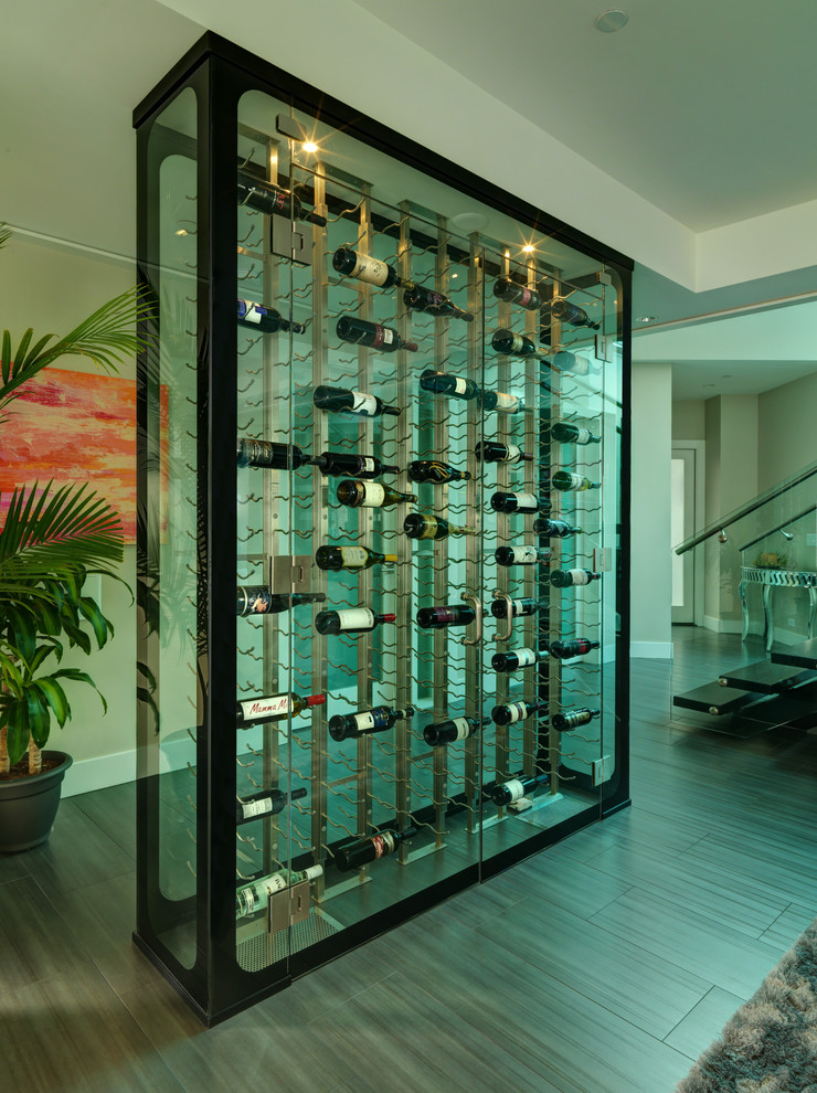 This is an example of a mid-sized modern wine cellar in Vancouver with display racks, medium hardwood floors and brown floor.