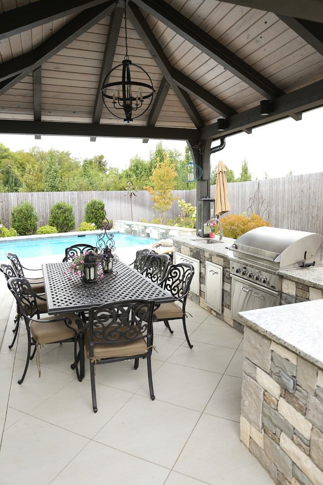 Patio kitchen - large transitional backyard tile patio kitchen idea with a gazebo