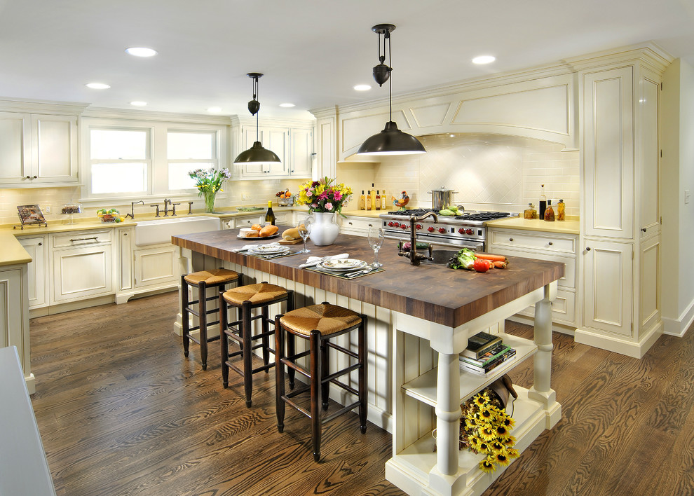 Design ideas for a traditional kitchen in Chicago with stainless steel appliances, a farmhouse sink, wood benchtops and yellow benchtop.
