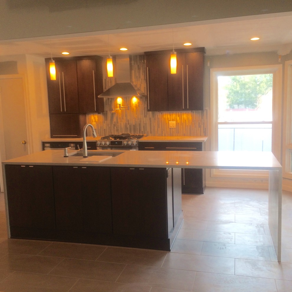 Eat-in kitchen - modern l-shaped ceramic tile eat-in kitchen idea with an undermount sink, flat-panel cabinets, dark wood cabinets, marble countertops, multicolored backsplash, matchstick tile backsplash, stainless steel appliances and an island