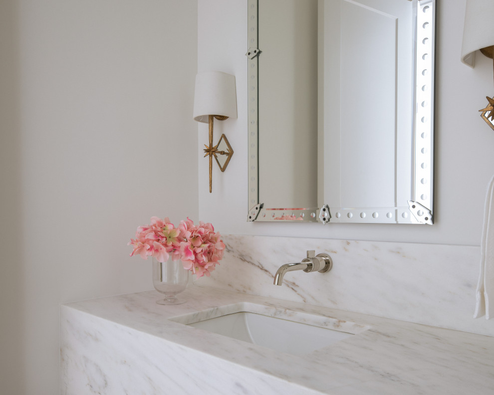 Inspiration for a beach style powder room in Dallas with a two-piece toilet, white walls, light hardwood floors, an undermount sink, marble benchtops, beige floor, white benchtops and a floating vanity.
