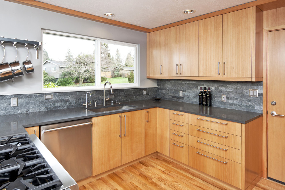 Photo of a contemporary kitchen in Seattle with stainless steel appliances and slate splashback.