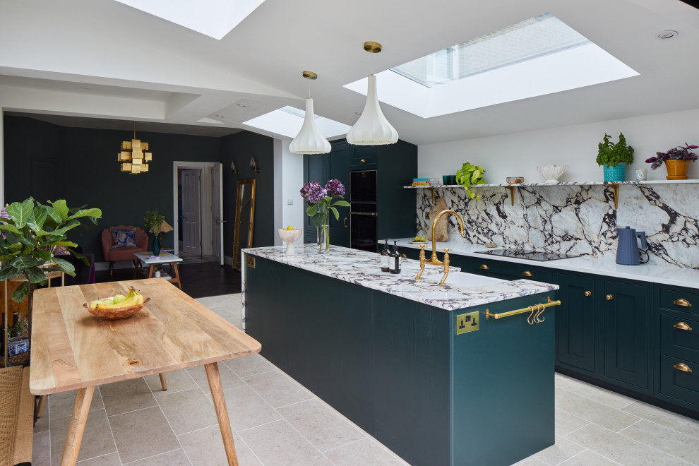 Design ideas for a mid-sized contemporary single-wall eat-in kitchen in London with shaker cabinets, green cabinets, marble benchtops, marble splashback, with island, beige floor, exposed beam, a farmhouse sink, multi-coloured splashback, panelled appliances, porcelain floors and multi-coloured benchtop.