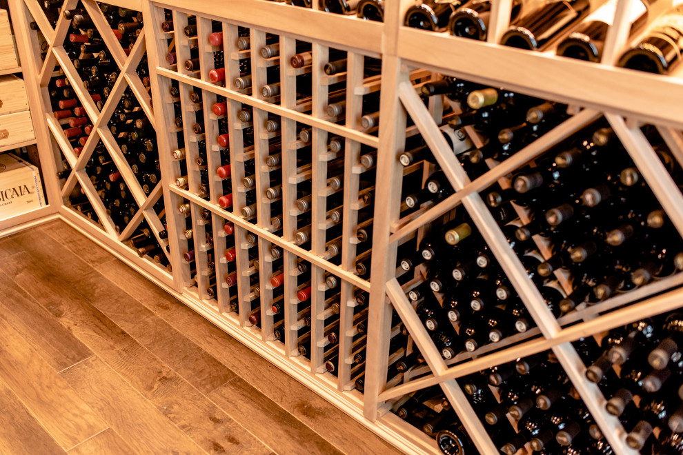 Mid-sized contemporary wine cellar in Dallas with storage racks and brown floor.