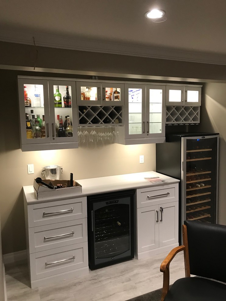Design ideas for a modern home bar in Vancouver with shaker cabinets, white cabinets, white floor, marble benchtops and white benchtop.