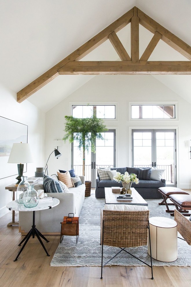 Inspiration for a large country open concept living room in Salt Lake City with white walls and light hardwood floors.