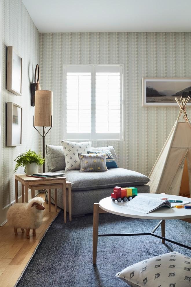 Inspiration for a mid-sized contemporary gender-neutral kids' playroom for kids 4-10 years old in New York with beige walls, light hardwood floors and brown floor.