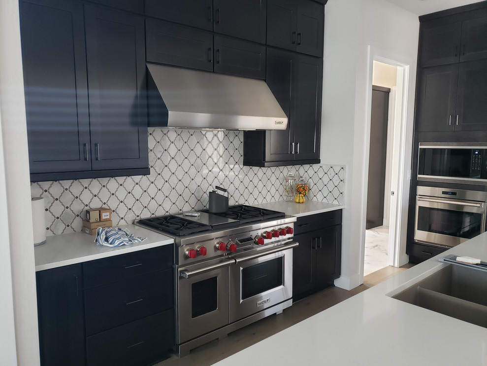 Example of a huge transitional porcelain tile eat-in kitchen design in Phoenix with an undermount sink, shaker cabinets, dark wood cabinets, quartz countertops, multicolored backsplash, colored appliances, no island and white countertops