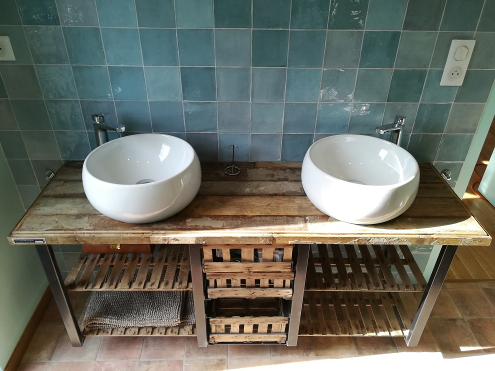 Large industrial master bathroom in Angers with open cabinets, distressed cabinets, green tile, terra-cotta tile, green walls, terra-cotta floors, a drop-in sink, wood benchtops, brown floor, multi-coloured benchtops, a double vanity and a floating vanity.