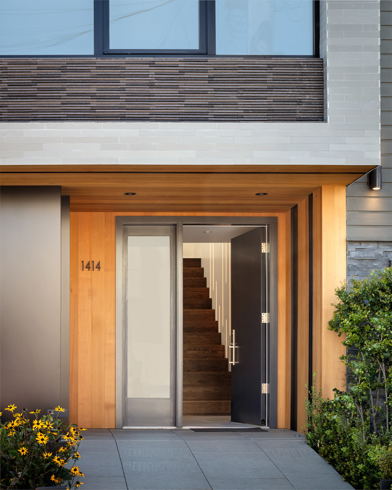 Photo of a contemporary front door in San Francisco with slate floors, a single front door, a dark wood front door and grey floor.