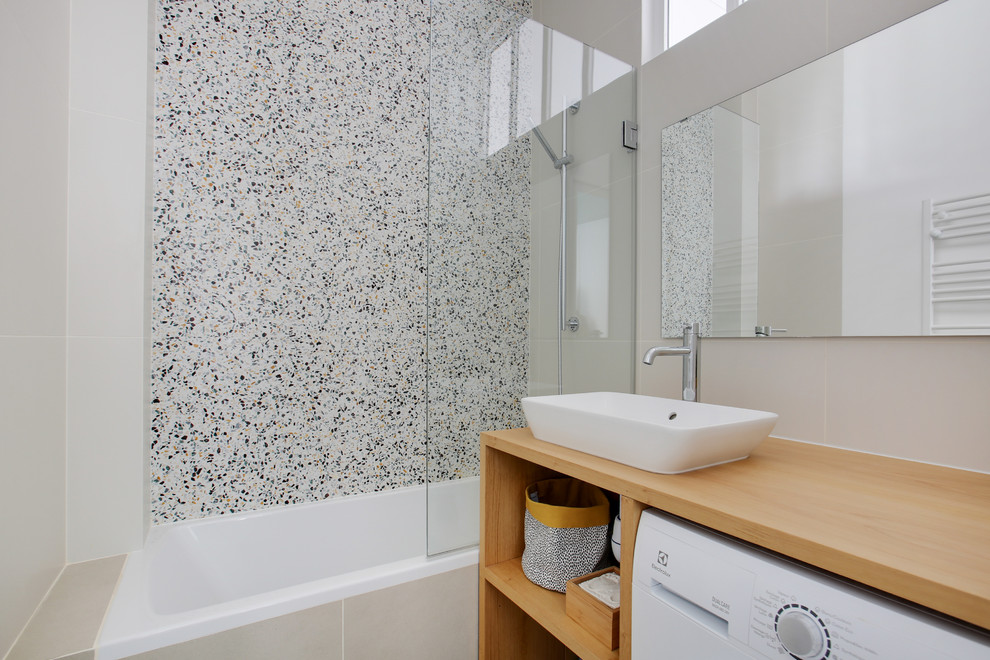 This is an example of a mid-sized contemporary kids bathroom in Paris with brown cabinets, an undermount tub, green tile, beige walls, terrazzo floors, a drop-in sink and beige benchtops.