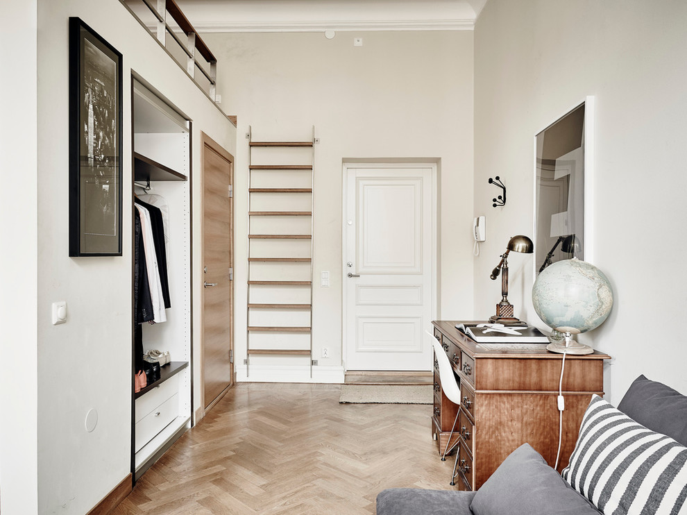 Inspiration for a mid-sized scandinavian entryway in Gothenburg with beige walls and light hardwood floors.