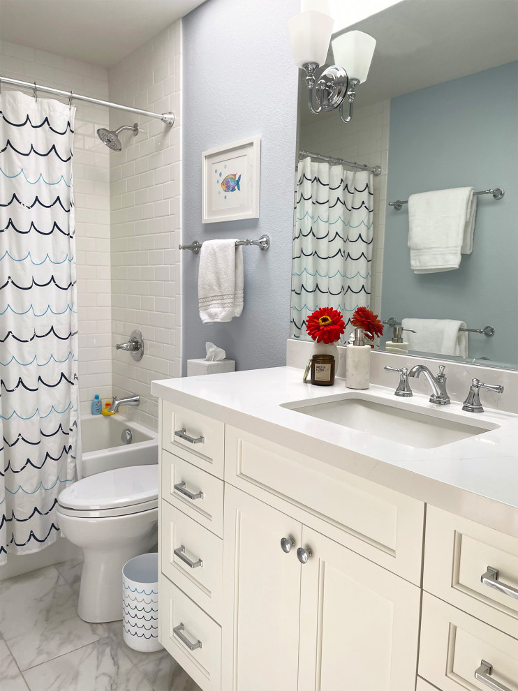 Inspiration for a small transitional kids bathroom with white cabinets, an alcove tub, a shower/bathtub combo, a two-piece toilet, white tile, ceramic tile, blue walls, porcelain floors, an undermount sink, engineered quartz benchtops, white floor, a shower curtain, white benchtops, a niche, a single vanity, recessed-panel cabinets and a built-in vanity.