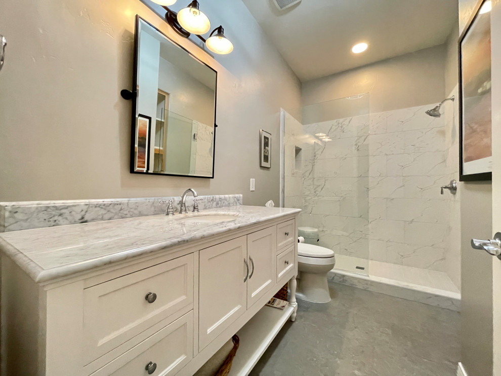 Inspiration for a large transitional master white tile and porcelain tile porcelain tile, gray floor and single-sink bathroom remodel in Phoenix with shaker cabinets, white cabinets, a one-piece toilet, gray walls, an undermount sink, marble countertops, white countertops, a niche and a freestanding vanity