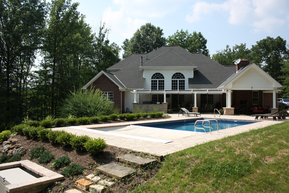 Mid-sized elegant backyard brick and rectangular lap pool photo