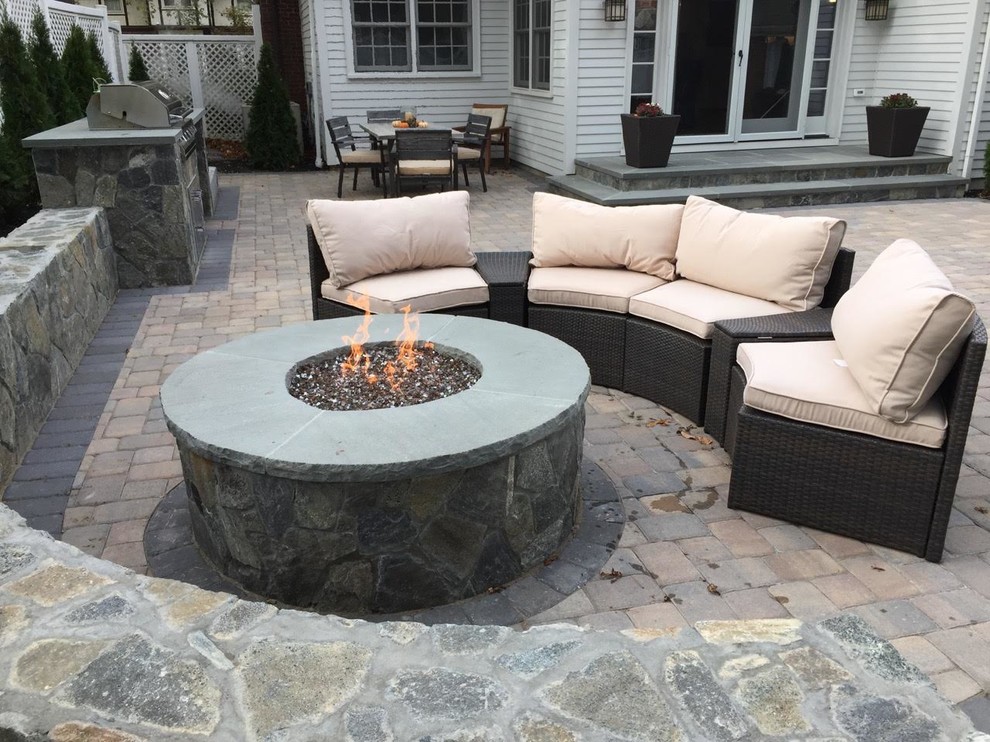 Mid-sized transitional backyard concrete paver patio photo in Orange County with a fire pit and no cover